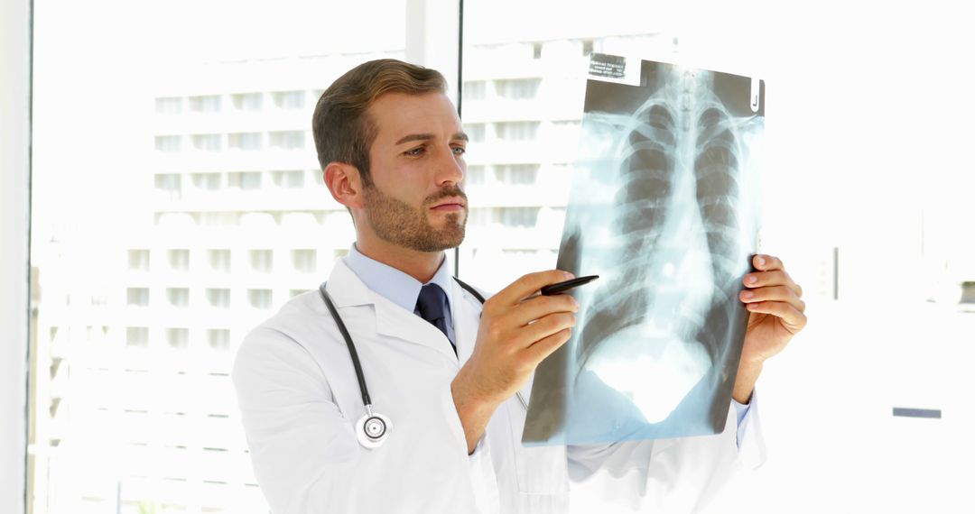 Male Doctor Examining Chest X-ray in Modern Hospital - Free Images, Stock Photos and Pictures on Pikwizard.com