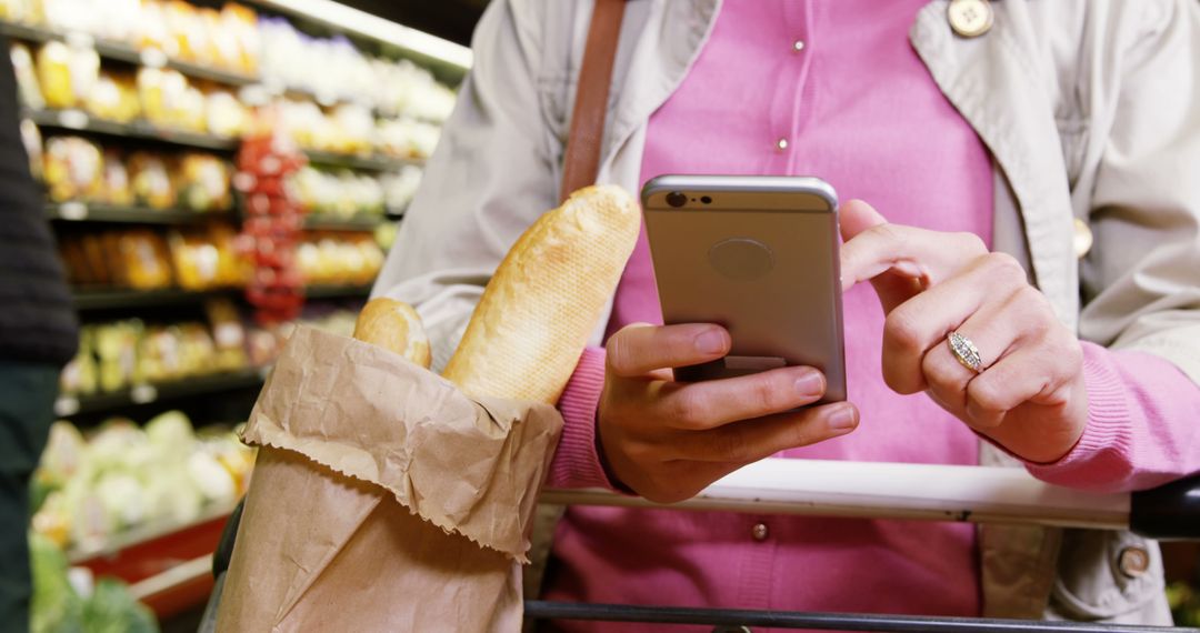 Woman Shopping at Grocery Store Checking Smartphone for Shopping List - Free Images, Stock Photos and Pictures on Pikwizard.com