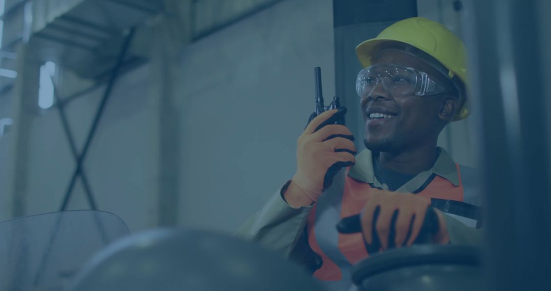 Warehouse Worker Operating Forklift with Safety Gear and Two-Way Radio