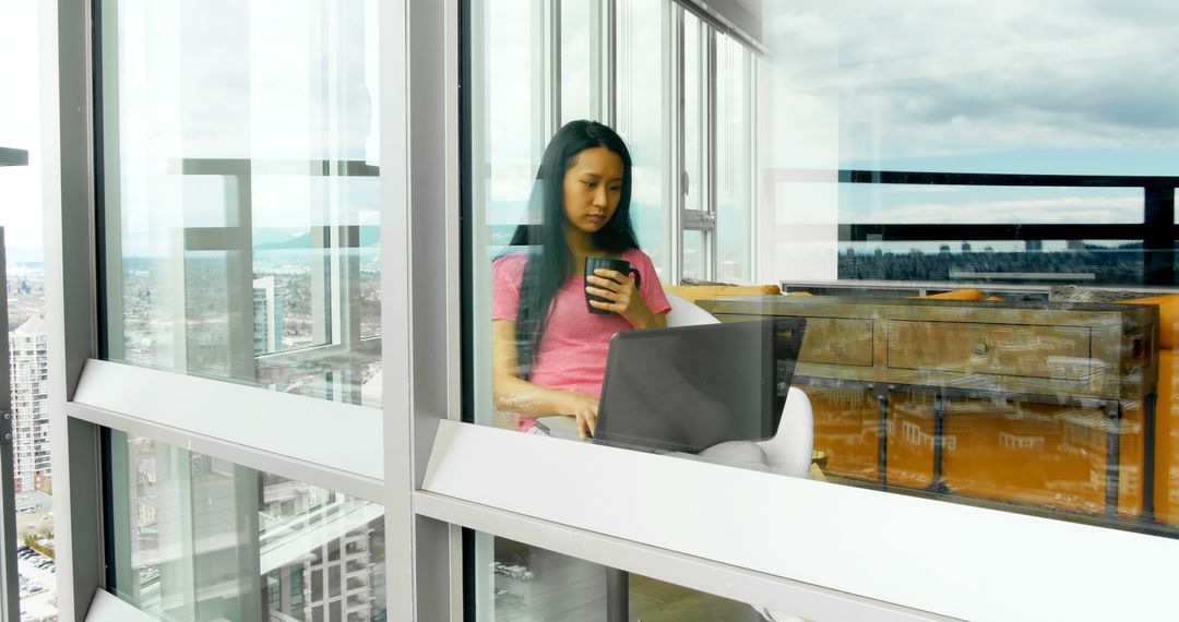 Woman Remote Working from Modern Apartment with City View - Free Images, Stock Photos and Pictures on Pikwizard.com