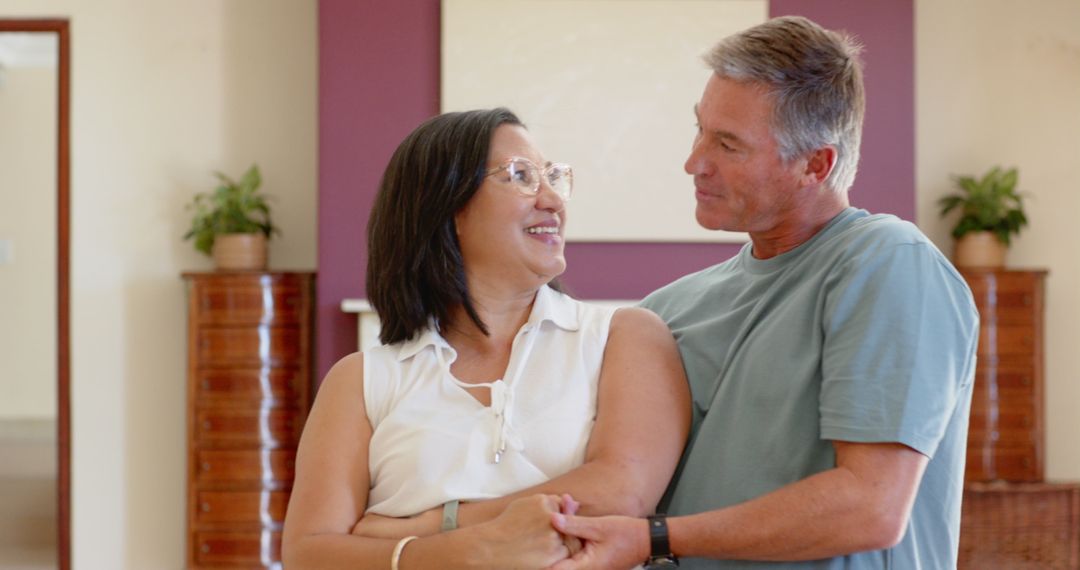 Diverse Senior Couple Embracing in Cozy Living Room