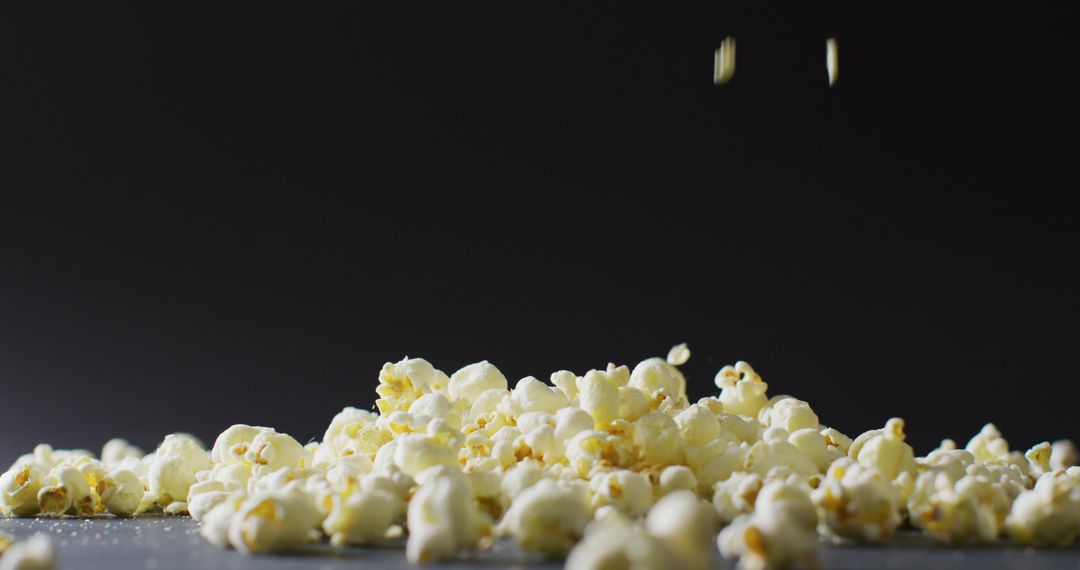 Close-Up of Popcorn Falling Against Dark Background - Free Images, Stock Photos and Pictures on Pikwizard.com