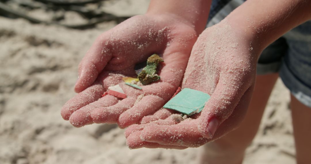 Hands Holding Microplastic Debris on Sandy Beach - Free Images, Stock Photos and Pictures on Pikwizard.com