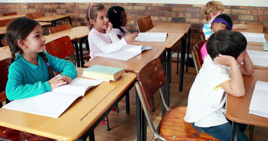 Young Children Learning in Classroom with Books on Desks - Free Images, Stock Photos and Pictures on Pikwizard.com