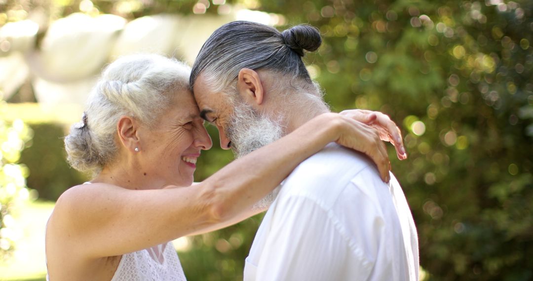 Senior Couple Embracing in Peaceful Garden Setting