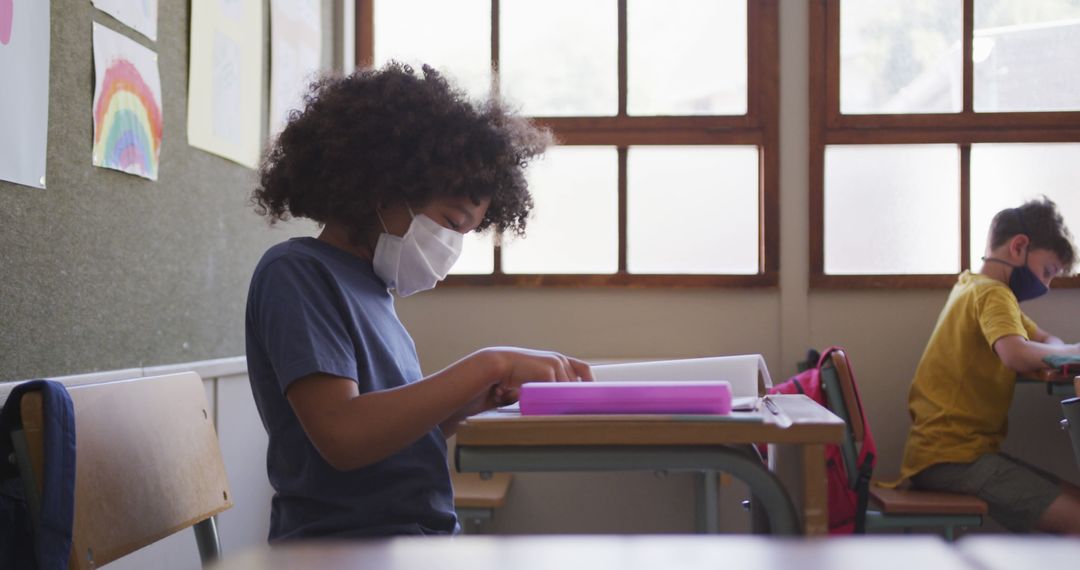 Young Students Wearing Masks Reading in Classroom - Free Images, Stock Photos and Pictures on Pikwizard.com