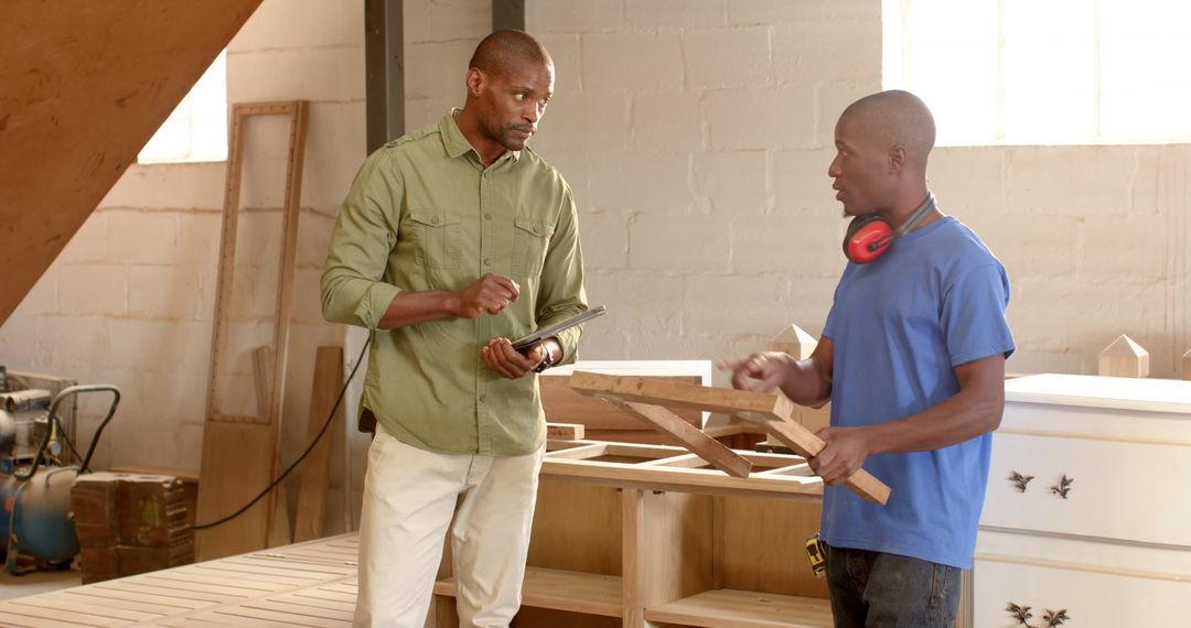 Teamwork in Woodworking Workshop with Tablet and Timber