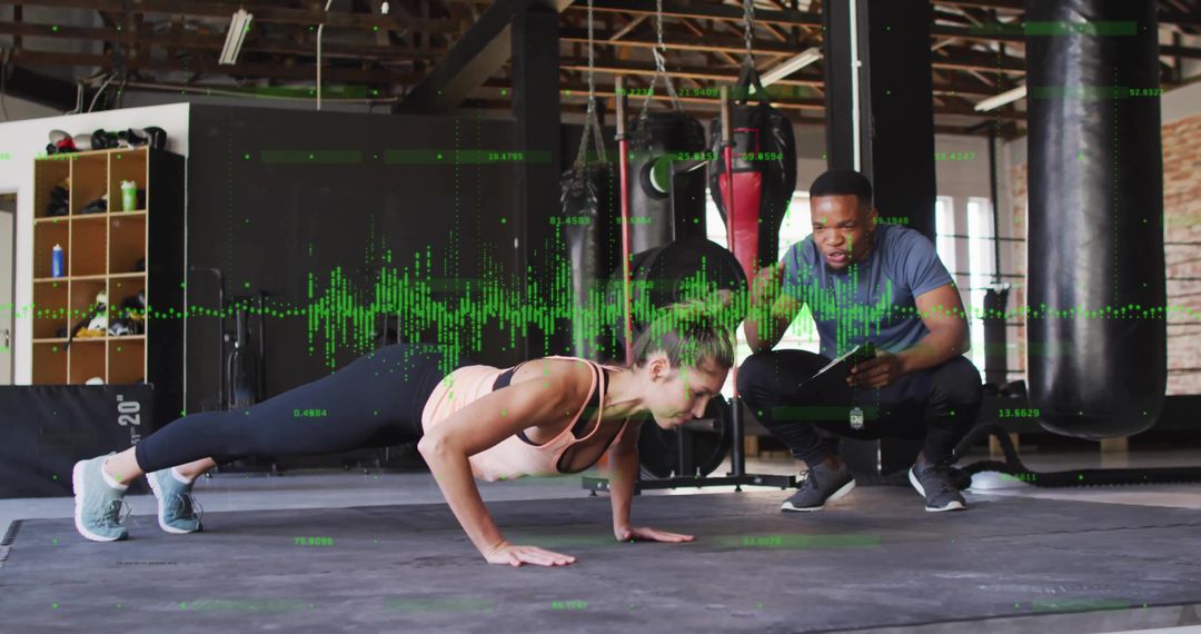 Personal Trainer Monitoring Client's Push-Up Form with Tablet Technology