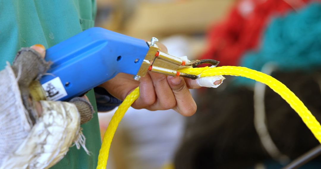 Close-up of person working with hand tool on yellow rope - Free Images, Stock Photos and Pictures on Pikwizard.com