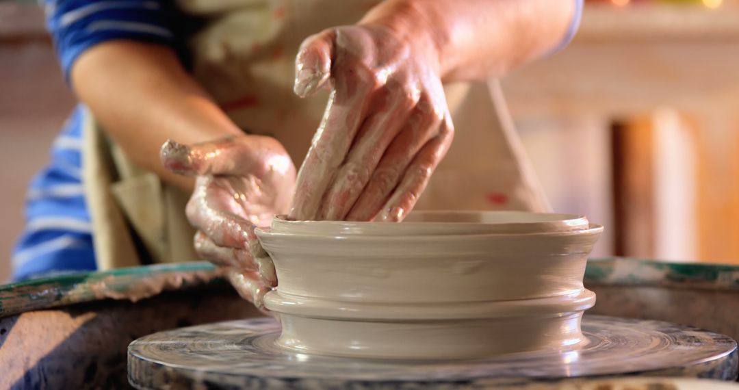 Closeup of Potter's Hands Shaping Clay on Pottery Wheel - Free Images, Stock Photos and Pictures on Pikwizard.com