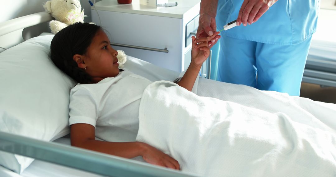 Nurse Checking Blood Sugar Levels of Young Girl in Hospital Bed - Free Images, Stock Photos and Pictures on Pikwizard.com