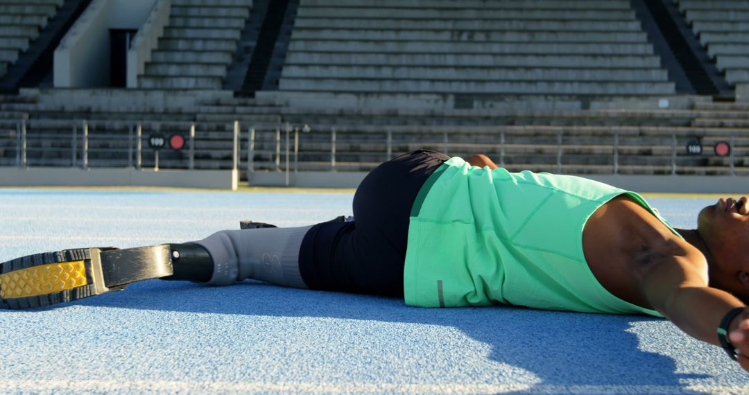 Athlete with Prosthetic Leg Stretching on Race Track - Free Images, Stock Photos and Pictures on Pikwizard.com