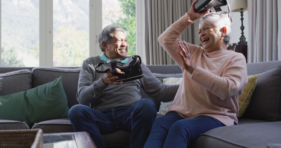 Senior Couple Enjoying Virtual Reality Gaming on Couch - Free Images, Stock Photos and Pictures on Pikwizard.com