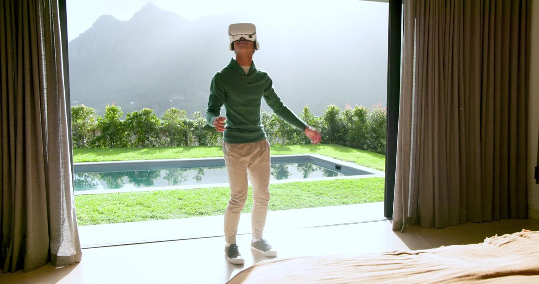 Man Using VR Headset with Scenic View Through Terrace Door