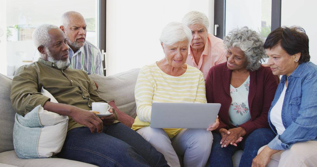 Group of Senior Friends Using Laptop Together on Couch - Free Images, Stock Photos and Pictures on Pikwizard.com