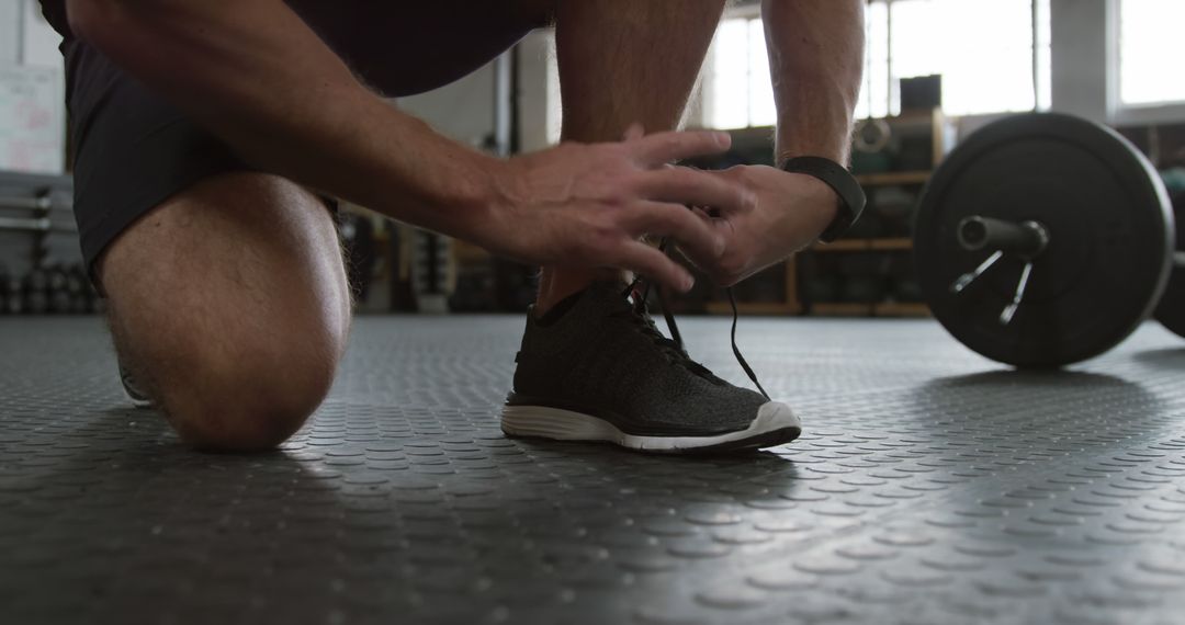 Close-Up of Athlete Tying Shoe Lace in Gym - Free Images, Stock Photos and Pictures on Pikwizard.com