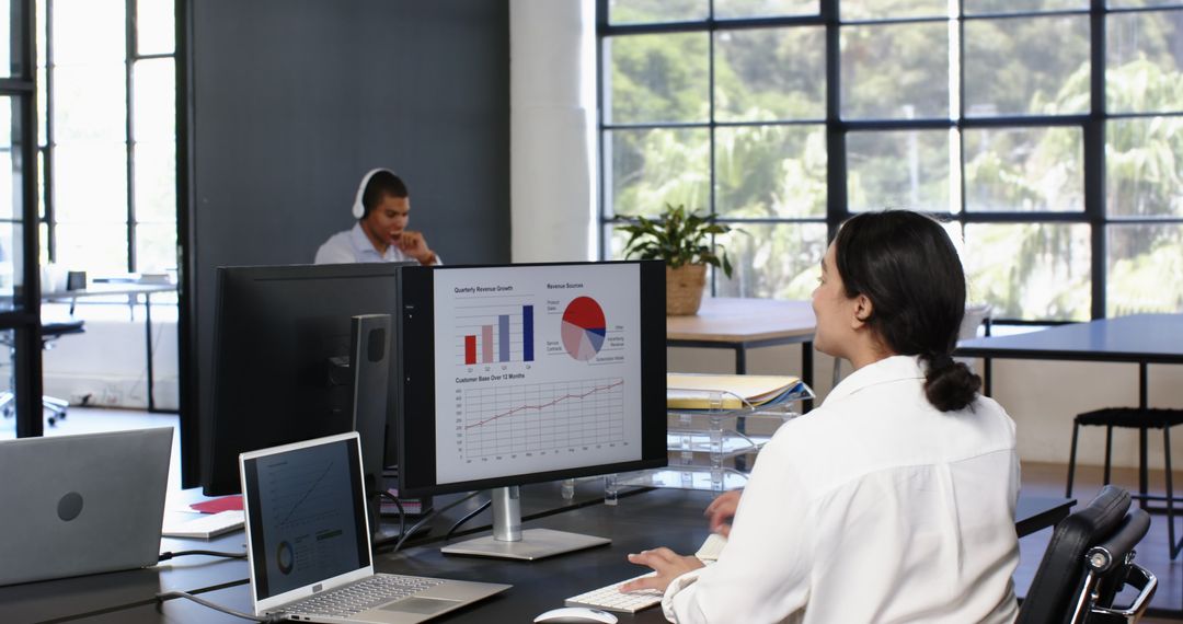 Business Team Collaborating on Sales Graphs in Modern Office