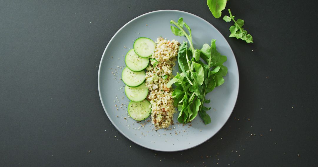 Healthy Vegan Quinoa Salad with Fresh Cucumber and Arugula on Gray Plate - Free Images, Stock Photos and Pictures on Pikwizard.com