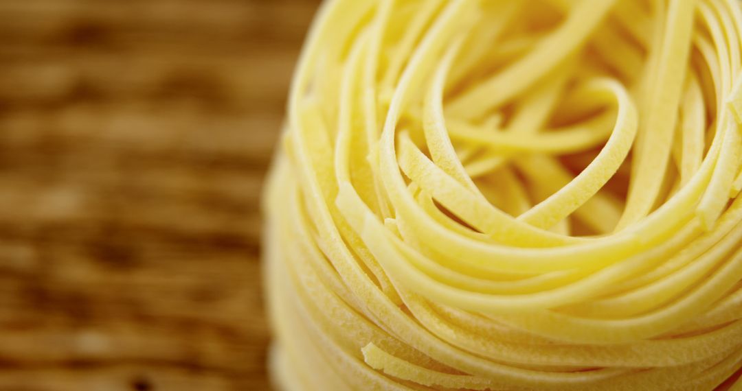 Close-Up of Linguine Pasta Nest on Wooden Background - Free Images, Stock Photos and Pictures on Pikwizard.com