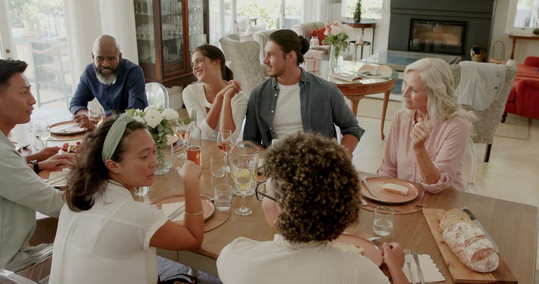 Diverse Group Sharing Meal and Stories at Dining Table
