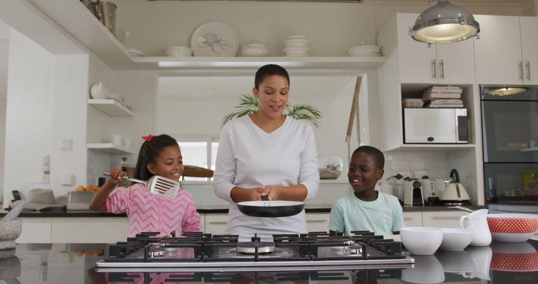 Mother Cooking with Happy Children in Modern Kitchen - Free Images, Stock Photos and Pictures on Pikwizard.com