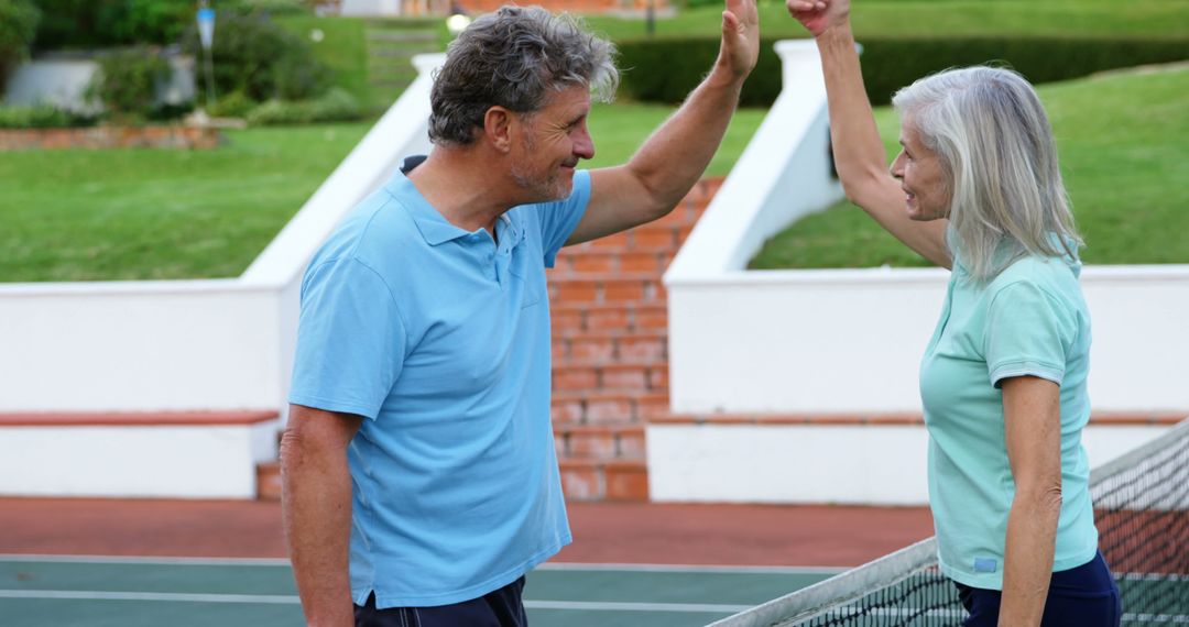 Senior Couple Celebrating at Tennis Court After Winning Game - Free Images, Stock Photos and Pictures on Pikwizard.com