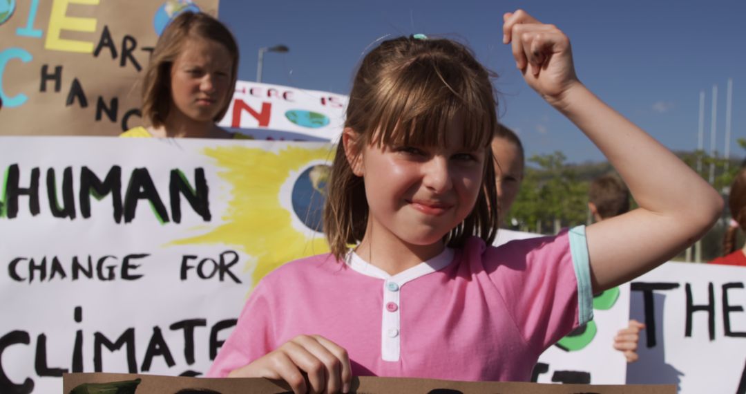 Young Activists Holding Climate Change Protest Signs Outdoors - Free Images, Stock Photos and Pictures on Pikwizard.com