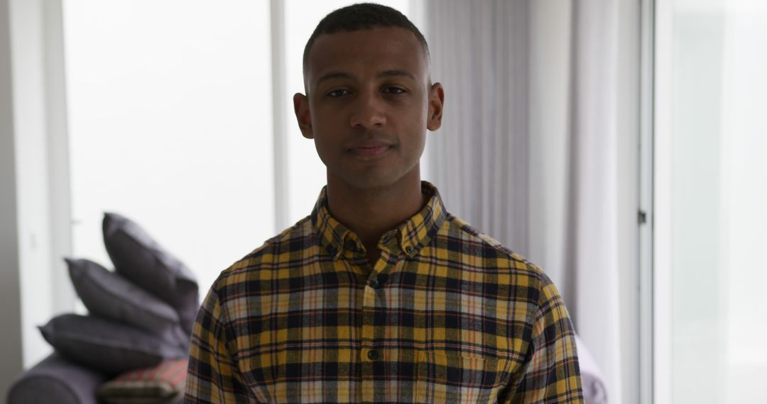 Smiling African American Man in Stylish Checkered Shirt at Home - Free Images, Stock Photos and Pictures on Pikwizard.com