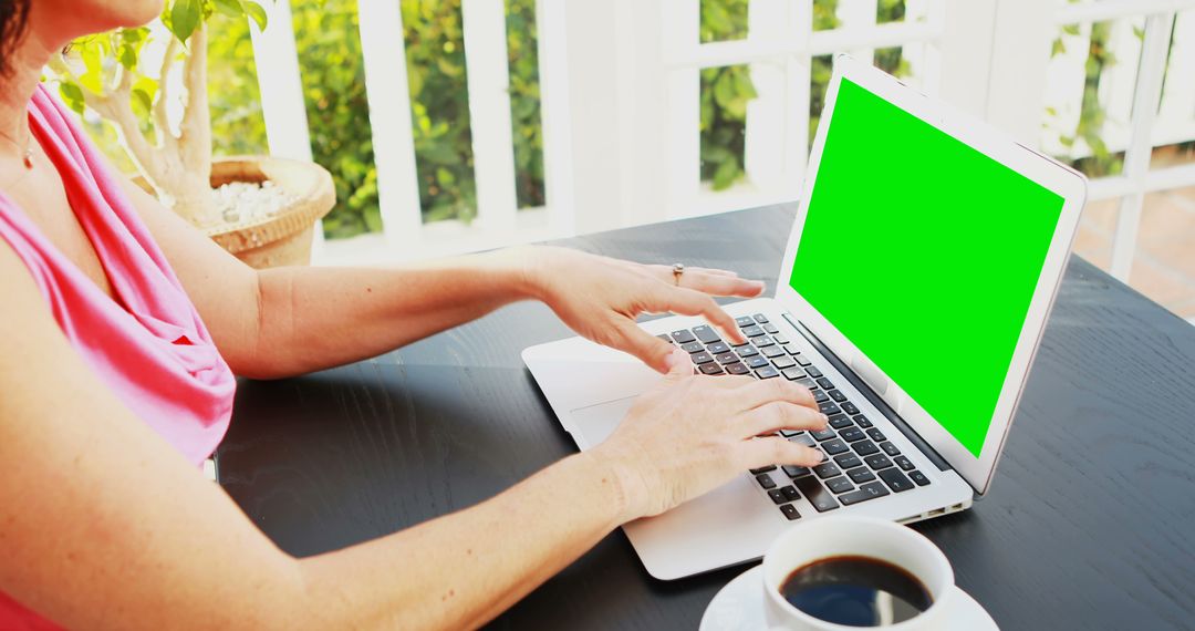 Woman Working on Laptop with Green Screen at Table with Coffee - Free Images, Stock Photos and Pictures on Pikwizard.com