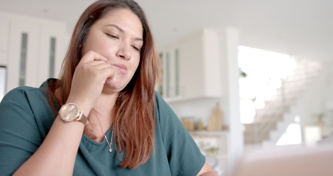 Thoughtful Plus Size Woman Contemplating While Working on Laptop