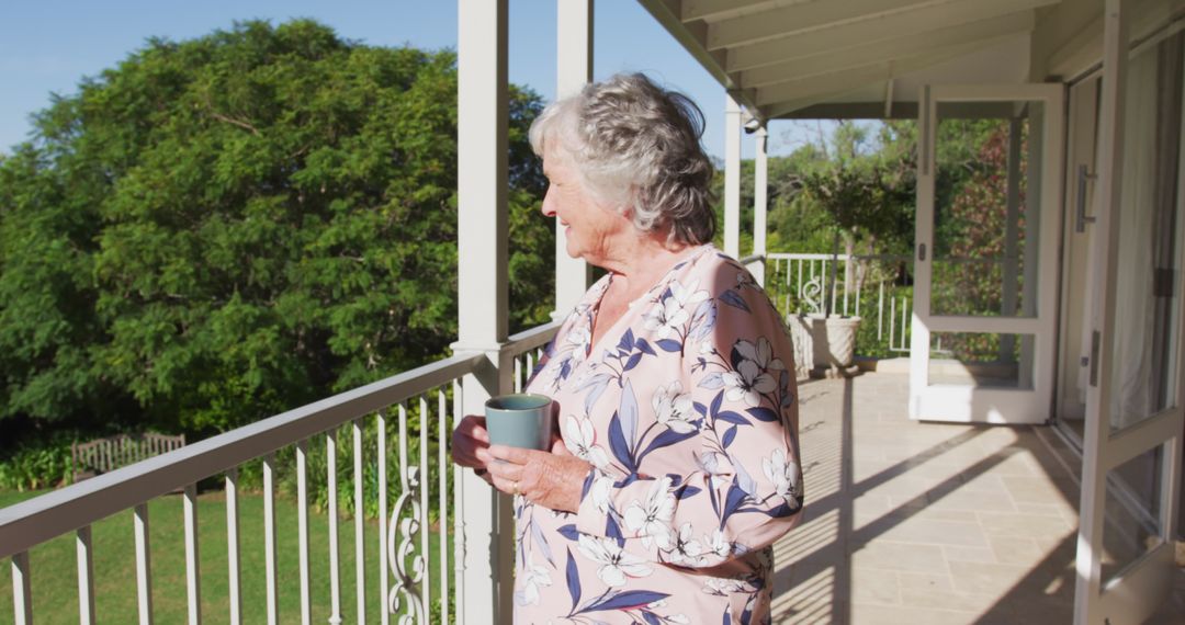 Elderly Woman Enjoying Coffee on Balcony in Garden - Free Images, Stock Photos and Pictures on Pikwizard.com