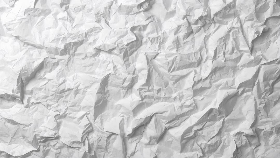 Crumpled White Paper Sheet Filling Frame Revealing Deep Folds and Soft Shadows
