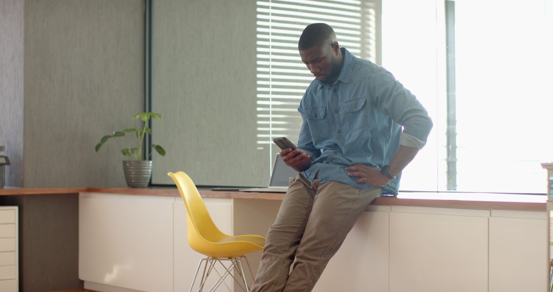 Professional Man Using Smartphone in Minimal Office