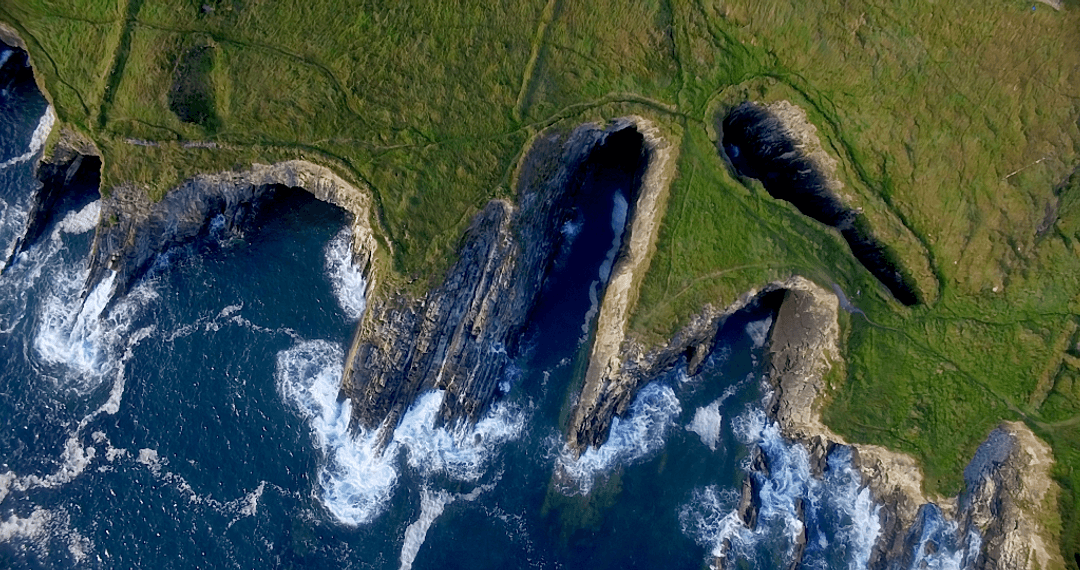 Transparent Emerald Cliffs by the Sea Are Striking Contrast
