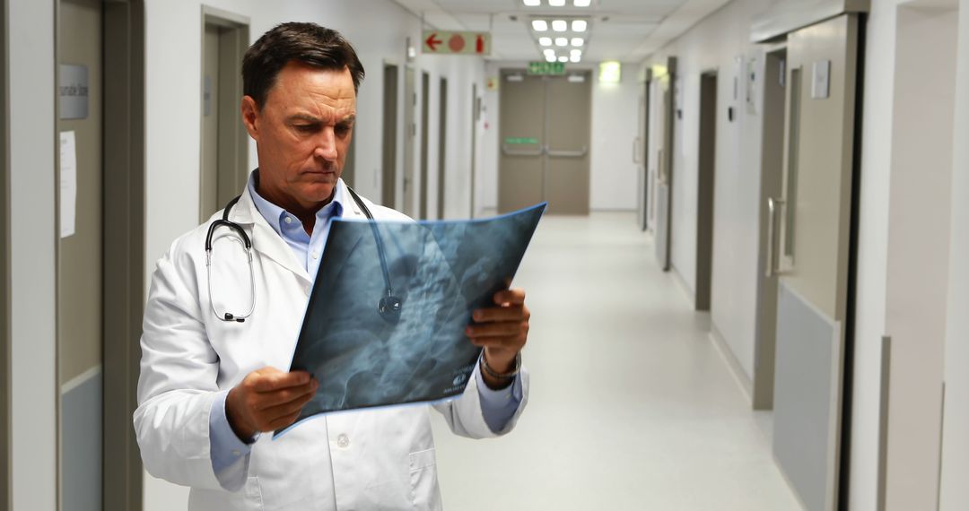 Doctor Analyzing X-ray in Hospital Corridor - Free Images, Stock Photos and Pictures on Pikwizard.com