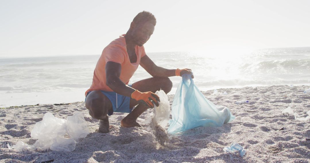 Man Cleaning Up Plastic Waste on Beach - Free Images, Stock Photos and Pictures on Pikwizard.com