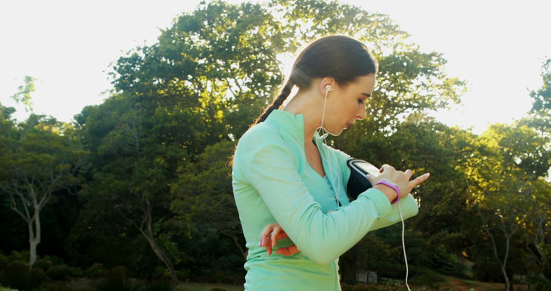 Female Athlete Checking Smartwatch During Outdoor Workout - Free Images, Stock Photos and Pictures on Pikwizard.com