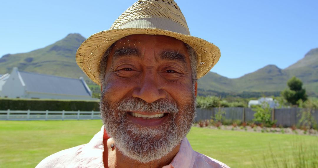 Smiling Elderly Man Wearing Straw Hat Outdoors on Sunny Day - Free Images, Stock Photos and Pictures on Pikwizard.com