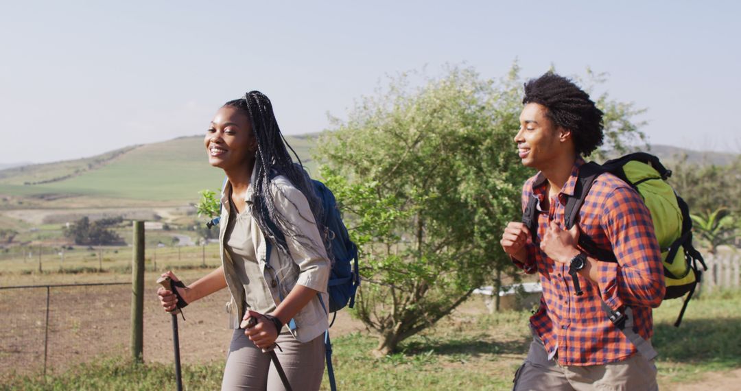 Young African American Couple Hiking in Countryside on Sunny Day - Free Images, Stock Photos and Pictures on Pikwizard.com