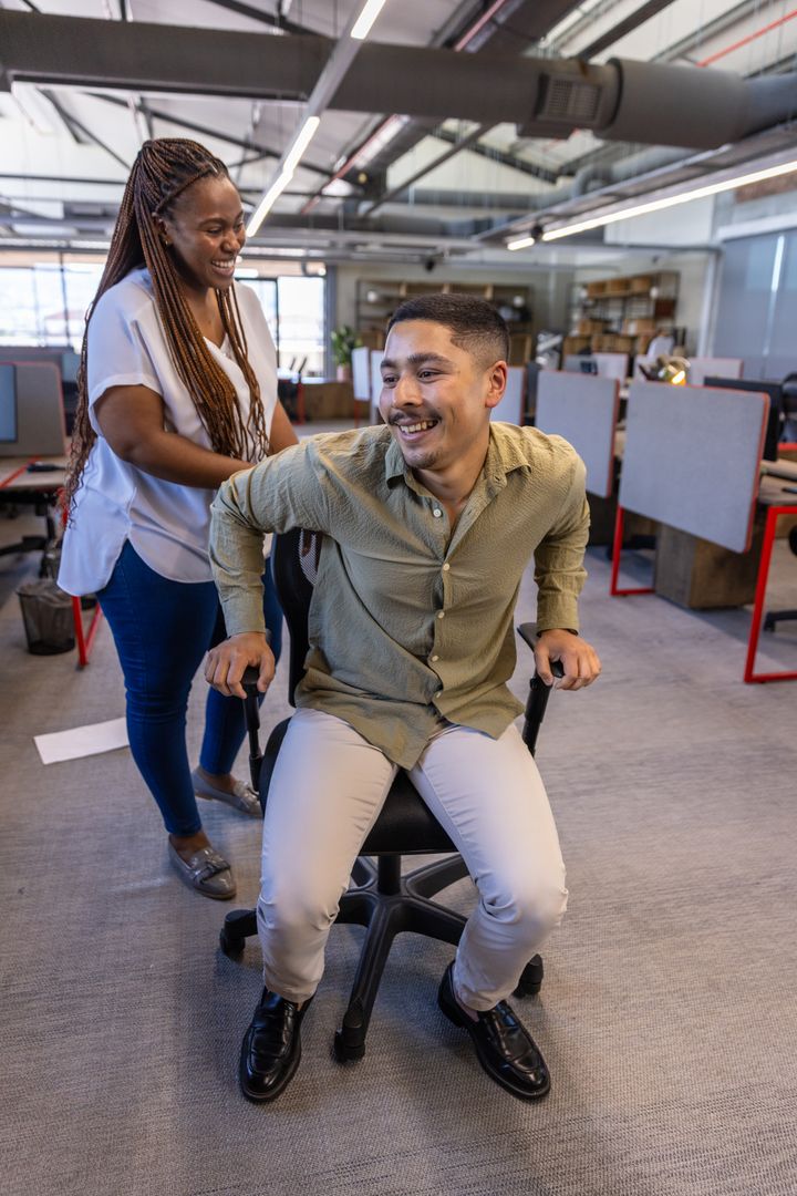 Dynamic Team Enjoying Workplace Humor in Modern Office