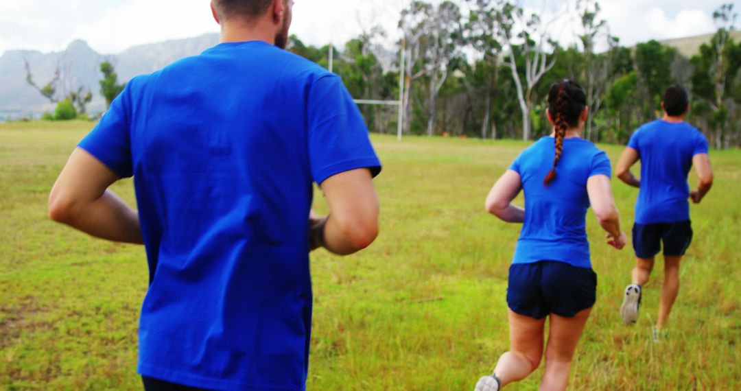 Group of Adults Jogging Outdoors in Blue Athletic Wear - Free Images, Stock Photos and Pictures on Pikwizard.com