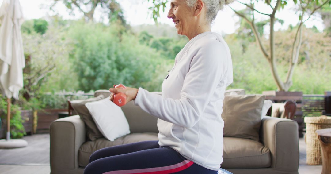 Senior Woman Exercising with Dumbbells in Outdoor Setting - Free Images, Stock Photos and Pictures on Pikwizard.com