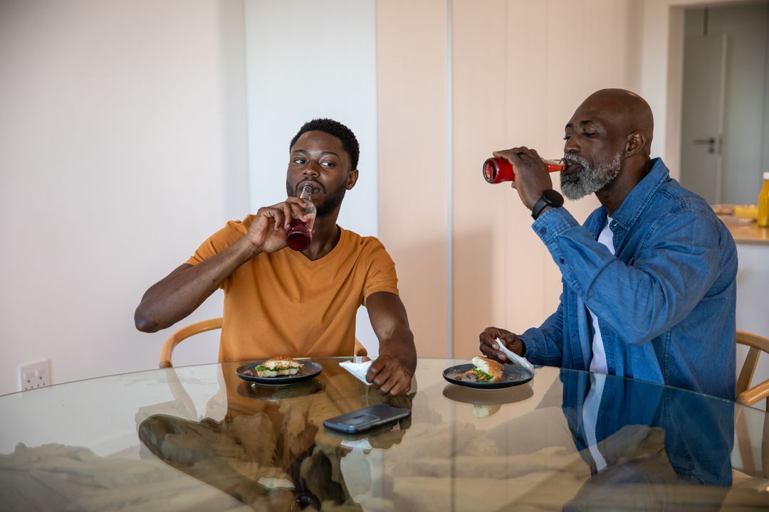 Father and Son Enjoying Avocado Toast and Refreshing Drinks in Kitchen