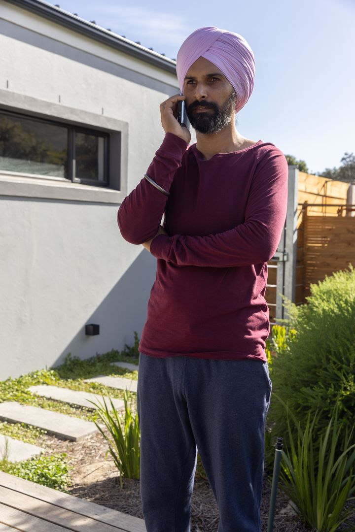 Indian Man Relaxing Outdoors Talking on Smartphone