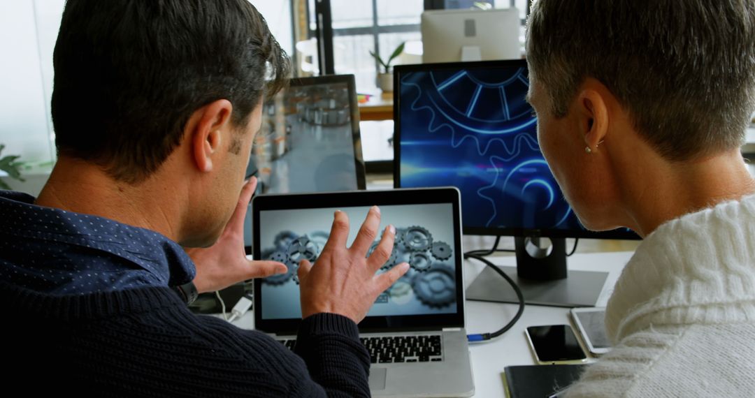 Two Engineers Discussing Mechanical Design on Laptop in Office - Free Images, Stock Photos and Pictures on Pikwizard.com