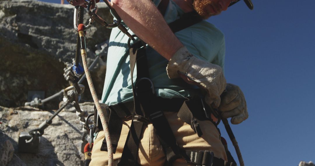 Close-Up of Rock Climber Adjusting Harness in Safety Gear - Free Images, Stock Photos and Pictures on Pikwizard.com