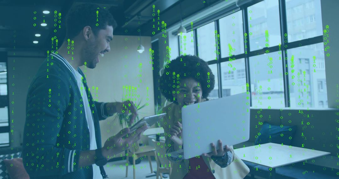 Collaborating on laptop and tablet in modern open office with green binary data overlay