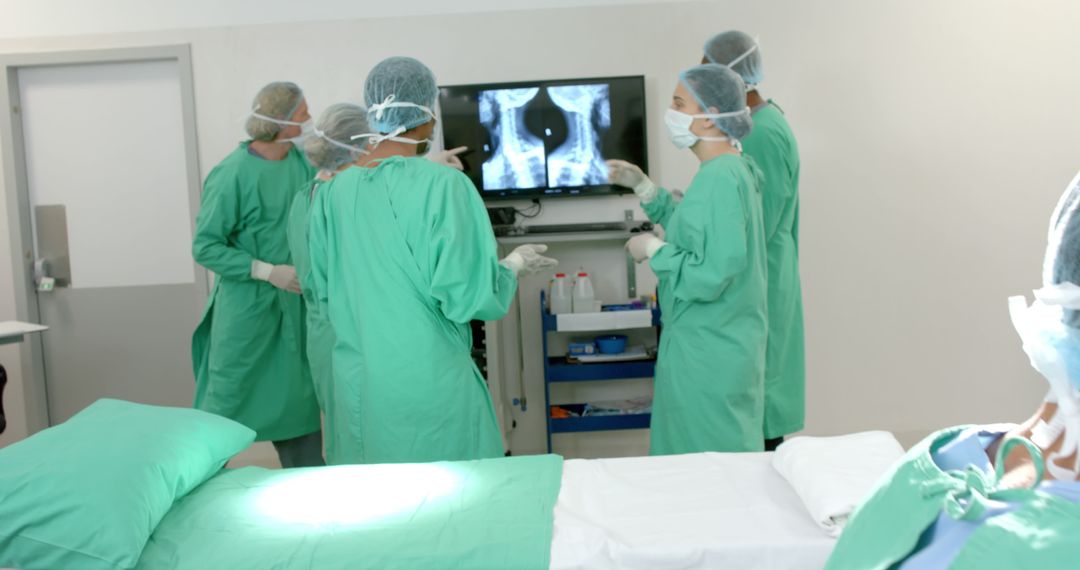 Medical Team Discussing Patient X-Ray in Operating Room - Free Images, Stock Photos and Pictures on Pikwizard.com