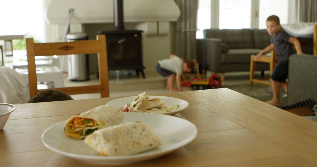 Children Playing Indoors near Table with Tortilla Wraps and Snacks - Free Images, Stock Photos and Pictures on Pikwizard.com