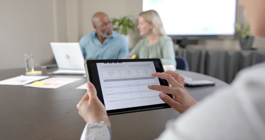 Diverse Team Meetings in Modern Office with Tablets and Laptops